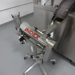 An Index Capsule Polisher connected to an Index K120i capsule filler.