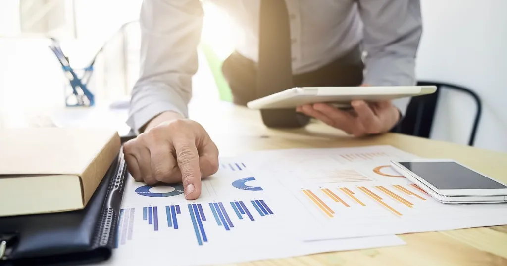 A person analyzing ROI data and charts.