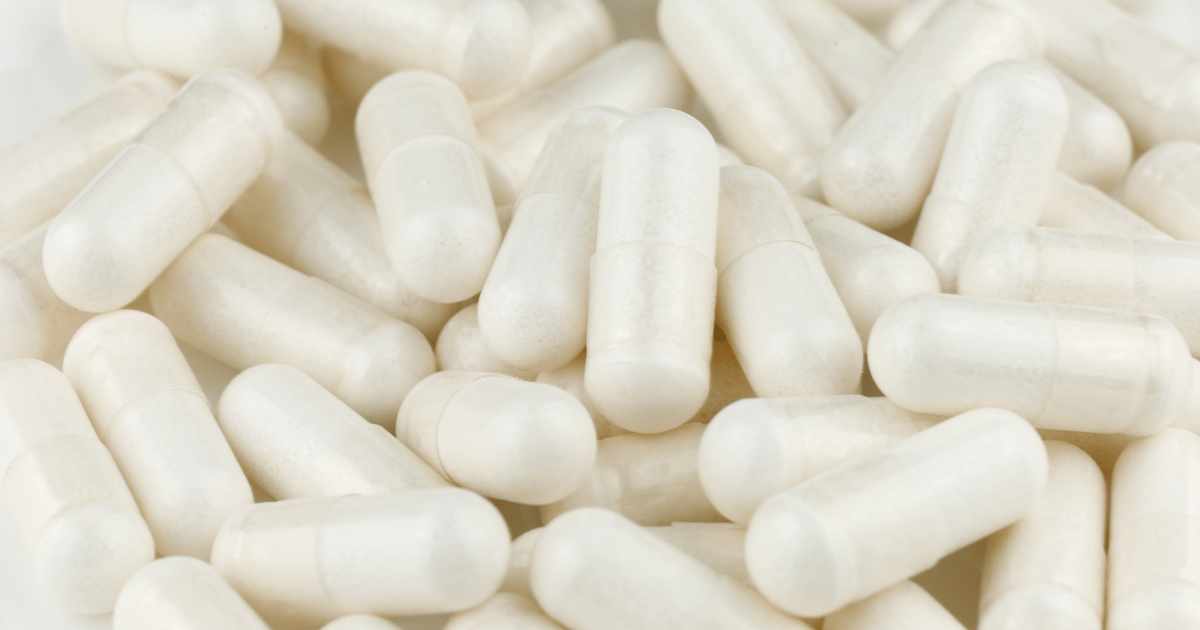 Close up shot of a pile of white capsules.