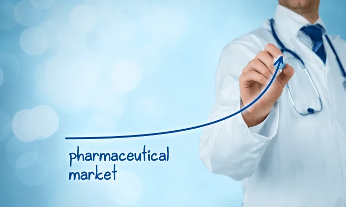 Doctor drawing upward curve labeled pharmaceutical market, symbolizing growth, future trends, and need for encapsulation equipment.